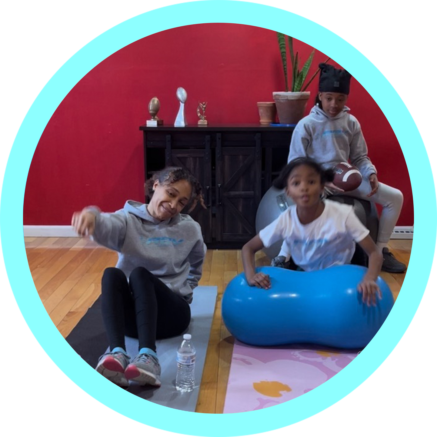 Three children sitting on the floor in a circle.