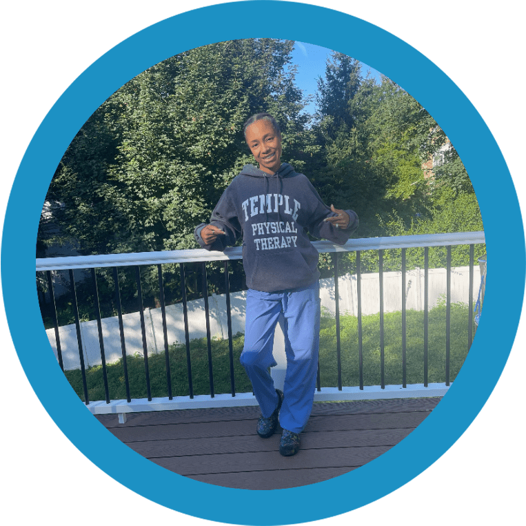 A man standing on top of a wooden deck.