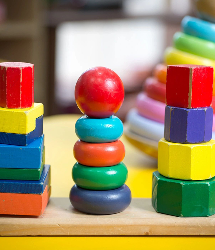 A stack of colorful blocks and a red ball.