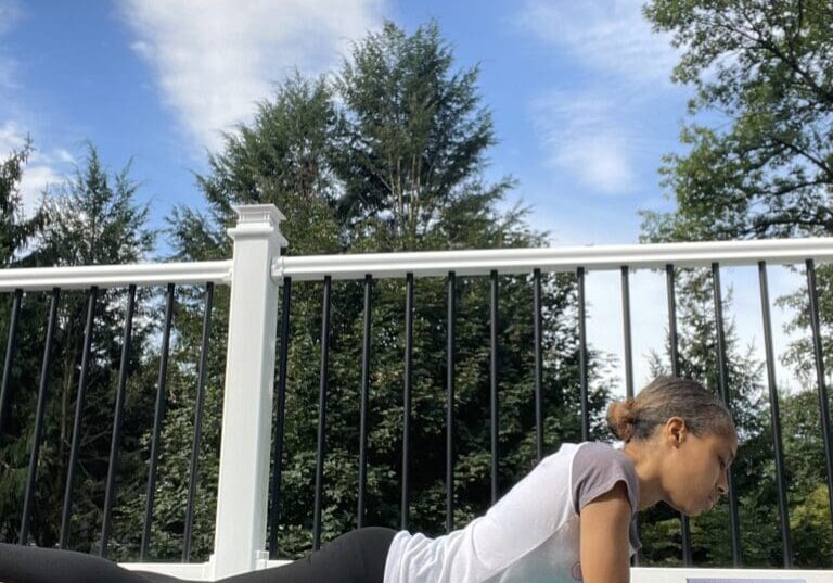 A woman is doing yoga on the ground